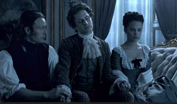 Dr. Struensee (Mads Mikkelsen), the Danish King Christian (Mikkel Boe Følsgaard), and Queen Caroline (Alicia Vikander)