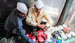 Dabbawallahs prepare lunchboxes for delivery